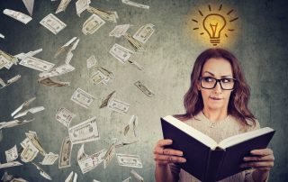 student reading a book has a bright idea how to earn money